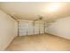 Spacious two car garage with finished concrete flooring and overhead storage racks at 43639 W Blazen Trl, Maricopa, AZ 85138