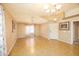 Spacious living room with tile floors, neutral walls, and large windows at 43639 W Blazen Trl, Maricopa, AZ 85138