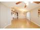 Open-concept living room with tile flooring and lots of natural light at 43639 W Blazen Trl, Maricopa, AZ 85138