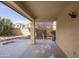 Covered patio featuring a finished concrete slab, backyard views, and retractable shade screens at 43639 W Blazen Trl, Maricopa, AZ 85138