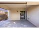 Extended covered patio featuring finished concrete flooring and backyard access via sliding glass door at 43639 W Blazen Trl, Maricopa, AZ 85138