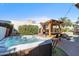 Luxurious backyard with a hot tub, outdoor bar area, lush landscaping, and a serene atmosphere at 4502 E Hartford Ave, Phoenix, AZ 85032
