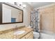 Cozy bathroom with granite counters, a single sink, and a shower-tub combo, designed for practical comfort at 4502 E Hartford Ave, Phoenix, AZ 85032