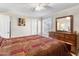 Cozy bedroom with a ceiling fan, window with plantation shutters, and a warm and inviting atmosphere at 4502 E Hartford Ave, Phoenix, AZ 85032