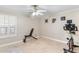Bright bonus room offers versatile space for exercise or hobbies, featuring tile floors, a ceiling fan, and natural light at 4502 E Hartford Ave, Phoenix, AZ 85032