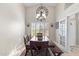 Bright dining room boasts a decorative clock and a rustic wooden table set for a comfortable dining experience at 4502 E Hartford Ave, Phoenix, AZ 85032