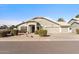 Charming single-story home with a three-car garage, desert landscaping, and a well-maintained front yard at 4502 E Hartford Ave, Phoenix, AZ 85032