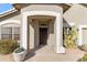 Inviting front porch with a decorative iron door, desert landscaping, and a neutral stucco exterior at 4502 E Hartford Ave, Phoenix, AZ 85032