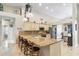Spacious kitchen featuring granite counters, stainless steel appliances, island with seating, and ample cabinet space at 4502 E Hartford Ave, Phoenix, AZ 85032