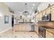 Open kitchen featuring granite counters, stainless steel appliances, and an island with bar seating, perfect for entertaining at 4502 E Hartford Ave, Phoenix, AZ 85032