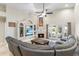 Inviting living room featuring a fireplace, ceiling fan, custom shelving, and comfortable seating at 4502 E Hartford Ave, Phoenix, AZ 85032