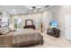 Serene main bedroom with a ceiling fan, plantation shutters, tile floors, and ample natural light at 4502 E Hartford Ave, Phoenix, AZ 85032