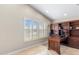 Bright office space with a large window, plantation shutters, built-in shelving, and tile flooring at 4502 E Hartford Ave, Phoenix, AZ 85032