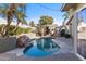 Private backyard oasis with a sparkling pool, a built-in grill, a covered patio, and lush tropical landscaping at 4502 E Hartford Ave, Phoenix, AZ 85032