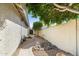 Landscaped walkway with stone features and lush greenery leading to the entrance of the home at 4502 E Hartford Ave, Phoenix, AZ 85032