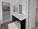 Bathroom featuring a double sink vanity with dark cabinets, and a view into the main bedroom at 4806 N 186Th Ln, Goodyear, AZ 85395