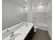Bright bathroom with double sinks and walk in shower at 4806 N 186Th Ln, Goodyear, AZ 85395