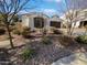 Landscaped front yard showcases desert plants, decorative rock, and a well-maintained exterior at 4806 N 186Th Ln, Goodyear, AZ 85395