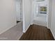 Hallway with wood floors, open to the kitchen and living area at 4806 N 186Th Ln, Goodyear, AZ 85395