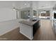 Open floor plan featuring a kitchen island with granite countertops and stainless steel appliances at 4806 N 186Th Ln, Goodyear, AZ 85395