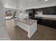 Modern kitchen features dark cabinetry, stainless steel appliances, granite countertops, and a large island at 4806 N 186Th Ln, Goodyear, AZ 85395