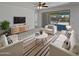 Bright living room features contemporary furniture, a ceiling fan, and sliding glass doors to the patio at 4806 N 186Th Ln, Goodyear, AZ 85395