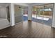 Bright living room with hardwood floors and sliding glass doors leading to the covered patio at 4806 N 186Th Ln, Goodyear, AZ 85395