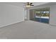 Spacious living area boasts natural light through sliding glass doors to the patio and neutral carpet at 4806 N 186Th Ln, Goodyear, AZ 85395