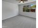 Main bedroom featuring a ceiling fan, carpet flooring and a window overlooking the backyard at 4806 N 186Th Ln, Goodyear, AZ 85395