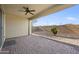 Covered back patio with a ceiling fan, brick pavers, and desert landscaping, perfect for outdoor relaxation and entertainment at 5628 S Winchester --, Mesa, AZ 85212