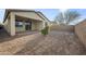 Large backyard with desert landscaping, patio, and privacy wall, offers a serene and low-maintenance outdoor living space at 5628 S Winchester --, Mesa, AZ 85212