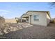 Backyard featuring low-maintenance desert landscaping, gravel ground cover, and a covered patio, perfect for outdoor enjoyment at 5628 S Winchester --, Mesa, AZ 85212