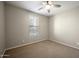 Cozy bedroom featuring plush carpet, neutral walls, ceiling fan, and bright window, creating a comfortable and inviting space at 5628 S Winchester --, Mesa, AZ 85212