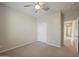 Clean bedroom featuring plush carpet, a ceiling fan, a closet, neutral walls, and a doorway to the rest of the home at 5628 S Winchester --, Mesa, AZ 85212