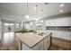 Open-concept kitchen with island, stainless steel appliances, and seamless flow to living area at 5628 S Winchester --, Mesa, AZ 85212