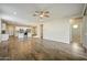 Open-concept layout with wood-look tile flooring, recessed lighting, and seamless flow to the kitchen at 5628 S Winchester --, Mesa, AZ 85212
