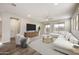 Bright living room with a modern white sectional sofa and sliding glass doors to the patio at 5628 S Winchester --, Mesa, AZ 85212