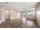 Spacious living room with wood-look tile flooring, ceiling fan, and sliding glass doors to the patio at 5628 S Winchester --, Mesa, AZ 85212