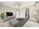 Comfortable main bedroom featuring neutral carpet, ceiling fan, and an en-suite bathroom at 5628 S Winchester --, Mesa, AZ 85212