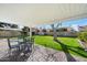 Cozy backyard patio with outdoor dining set overlooking a spacious, green lawn at 623 E Winter Drive Dr, Phoenix, AZ 85020