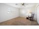 Cozy bedroom featuring a rocking chair, and neutral carpet paired with light walls and an abundance of natural light at 623 E Winter Drive Dr, Phoenix, AZ 85020