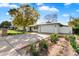 Well-maintained single-story home with a spacious driveway, two-car garage, and mature landscaping at 623 E Winter Drive Dr, Phoenix, AZ 85020
