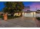 Beautiful home exterior with an attached two-car garage and large mature tree on the front lawn at 623 E Winter Drive Dr, Phoenix, AZ 85020