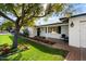 Charming front porch with seating area and lush landscaping with blooming flowers at 623 E Winter Drive Dr, Phoenix, AZ 85020
