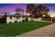 Well-manicured front yard of a lovely home, featuring vibrant green grass and mature trees at 623 E Winter Drive Dr, Phoenix, AZ 85020