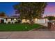Charming single-story home with lush green lawn and mature tree in the front yard at 623 E Winter Drive Dr, Phoenix, AZ 85020