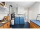 Functional laundry room with blue appliances, storage cabinets, and a countertop, offering convenience and organization at 623 E Winter Drive Dr, Phoenix, AZ 85020