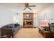 Cozy living room with a brick fireplace, wood floors, and open layout at 623 E Winter Drive Dr, Phoenix, AZ 85020