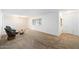 Spacious living room with neutral carpet, white walls, and a decorative glass coffee table and matching side chair at 623 E Winter Drive Dr, Phoenix, AZ 85020