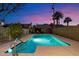 Backyard swimming pool with clear blue water, surrounded by lush landscaping and a secure fence at 623 E Winter Drive Dr, Phoenix, AZ 85020